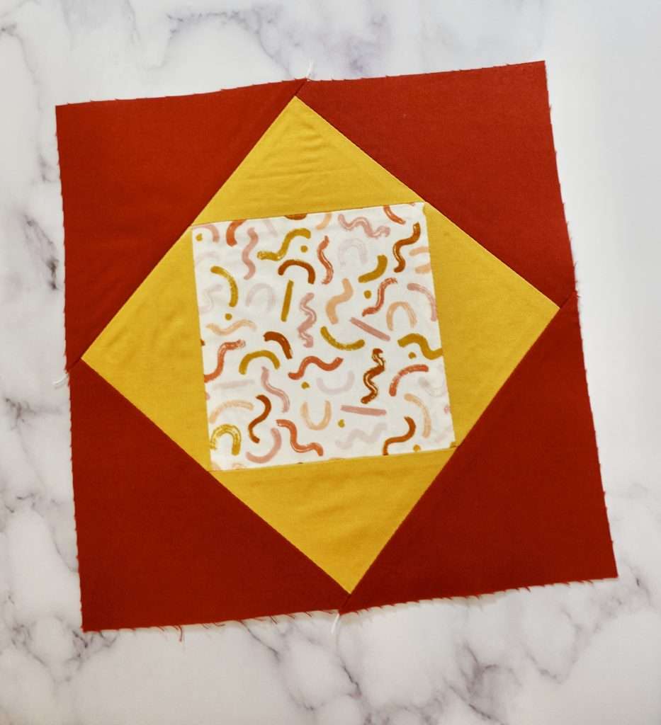 Economy Quilt Block step by step tutorial to make your own quilt. This Economy Quilt block uses the AccuQuilt fabric cutting machine to make the process easy & precise!