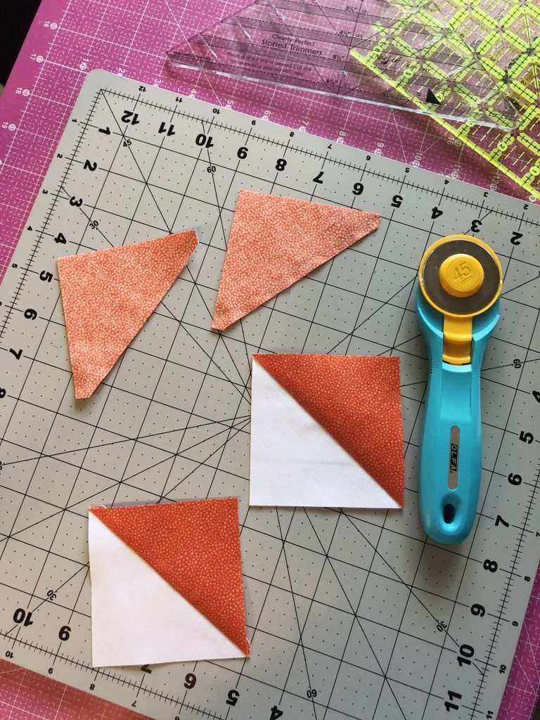 Half Square Triangle Quilt Blocks, learn how to make a quilt block, 4 at a time HSTs, quilt blocks, beginner quilting, learn to quilt, modern quilting, modern quilt pattern, triangular quilt pattern, rotary cutter, quilting rulers, trimming half square triangles