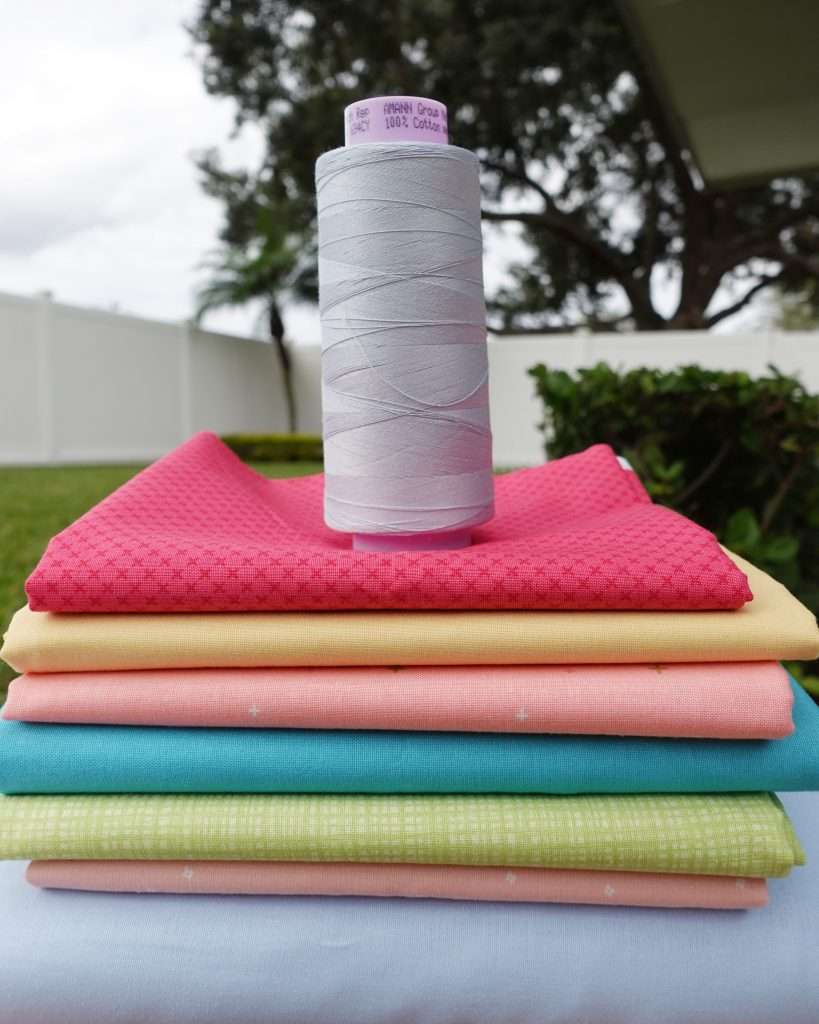 large cone of cotton thread for patchwork on a quilt
