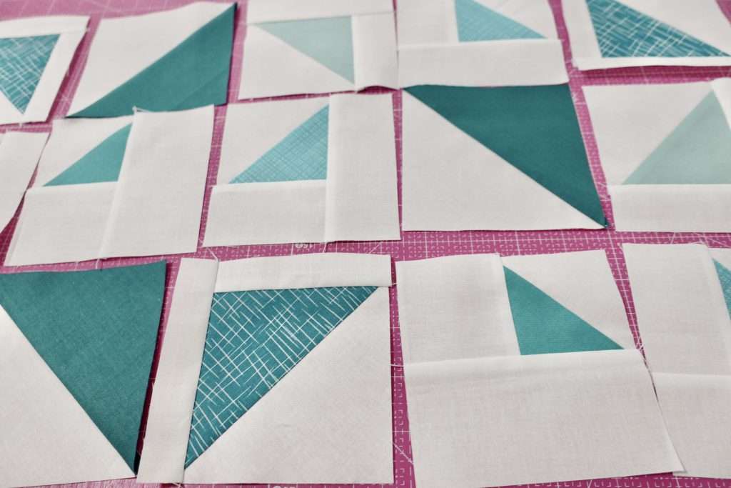 make a mini quilt out of different size half square triangle quilt blocks