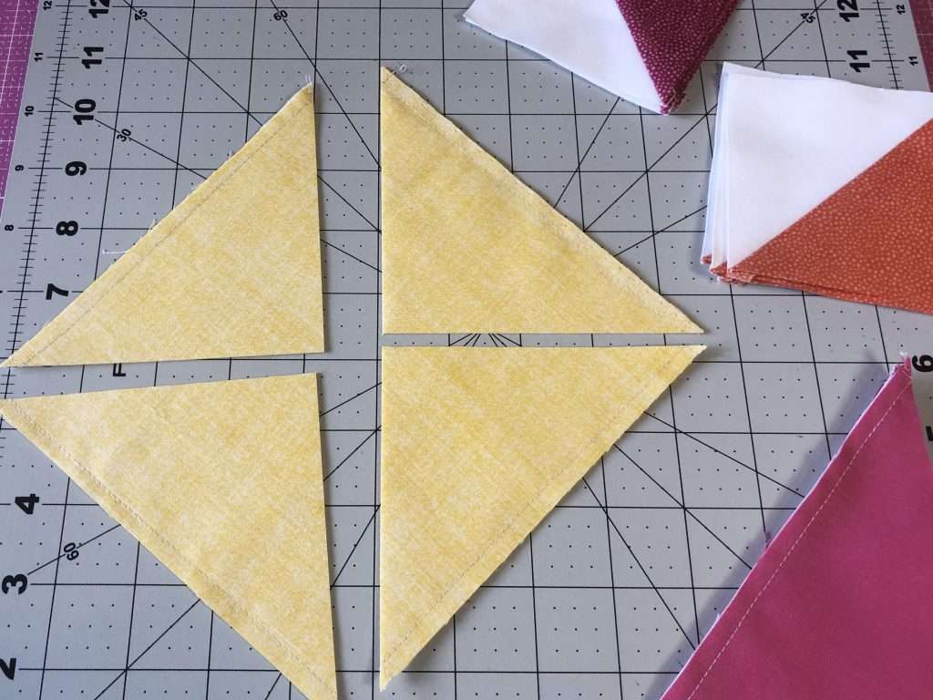 Half Square Triangle Quilt Blocks, learn how to make a quilt block, 4 at a time HSTs, quilt blocks, beginner quilting, learn to quilt, modern quilting, modern quilt pattern, triangular quilt pattern, rotary cutter, quilting rulers, trimming half square triangles